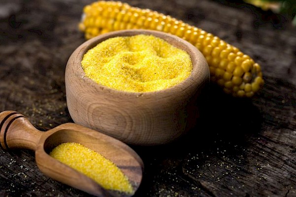 Cornmeal in a wooden bowl to be use as weed killer